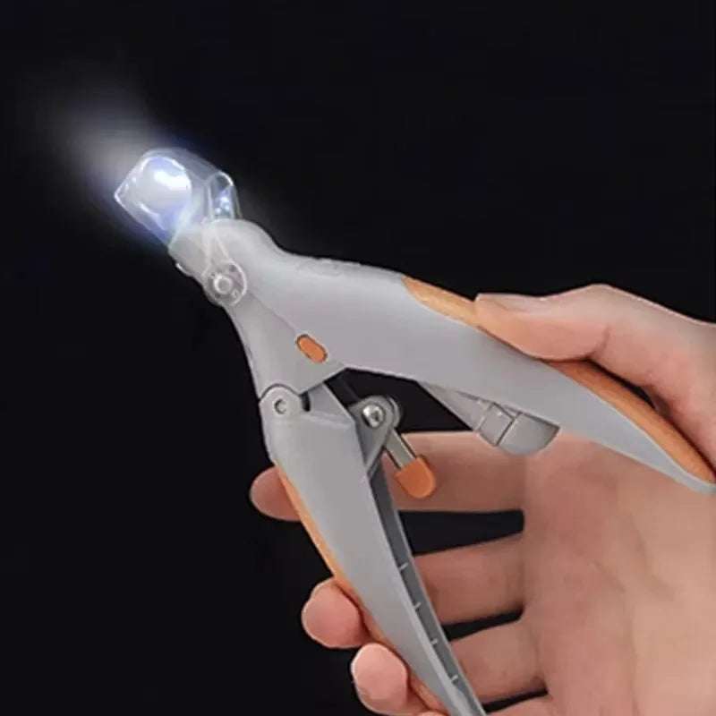 LED light pet nail clipper by S And B Enterprise, amplified nail trimmer for dogs and cats, gray with orange accents.