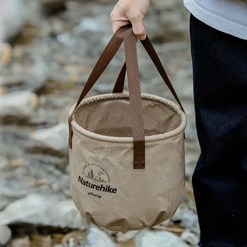 Naturehike handheld foldable waterproof bucket, beige with brown handles, portable camping storage.