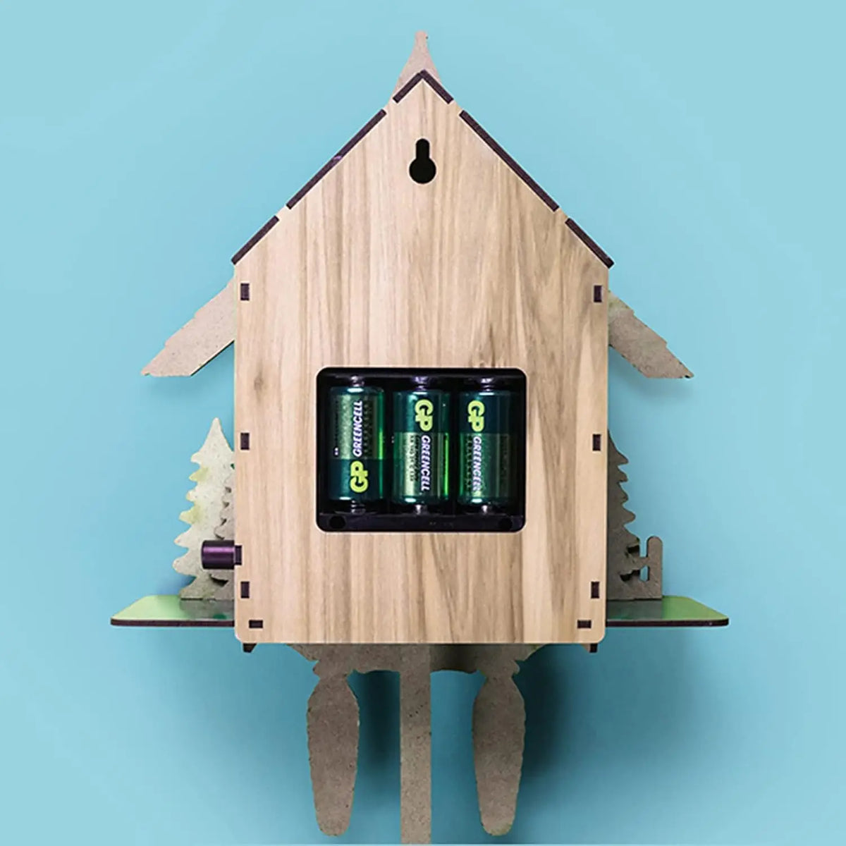 Wooden cuckoo wall clock by S And B Enterprise (CL-301) with visible battery compartment showing three AA batteries