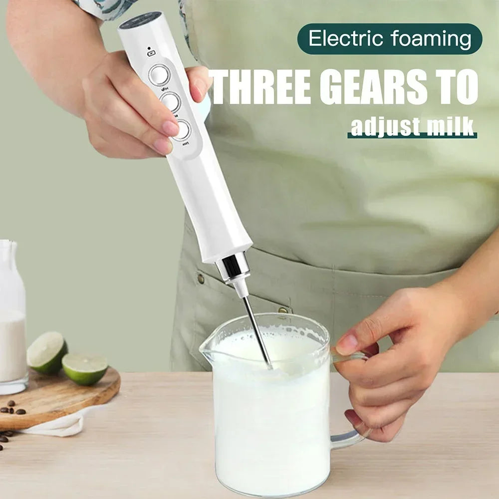 Milk frother handheld USB rechargeable; white plastic body with stainless steel whisk and 3-speed controls.