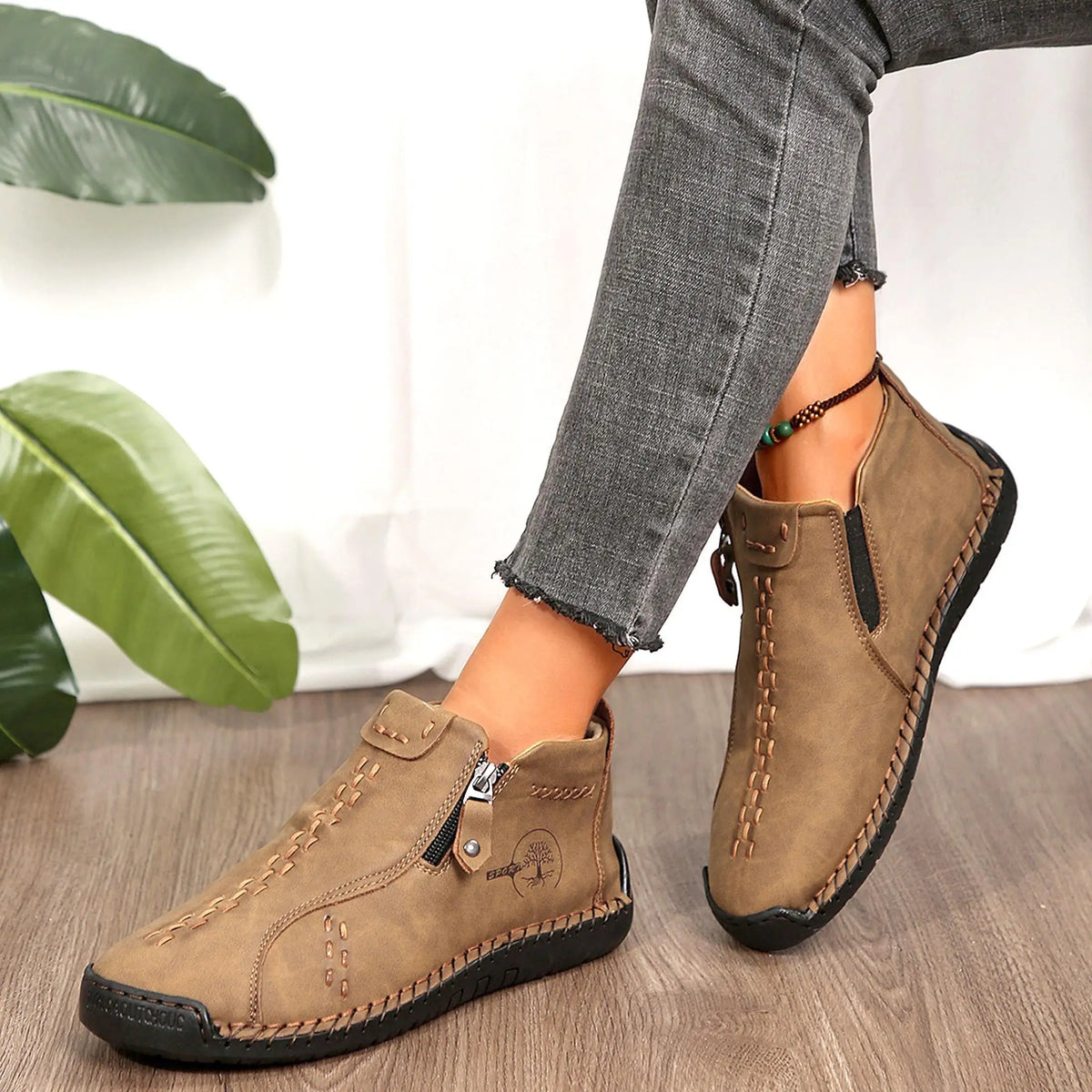 Pair of tan suede women’s slip-on loafers with moccasin stitching and durable rubber sole.