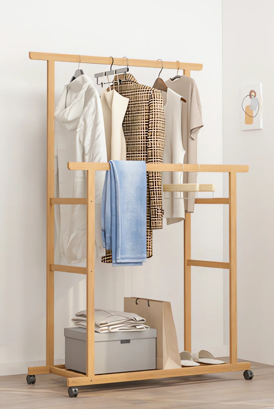 Bamboo freestanding clothes rack with two hanging rails on wheels and a bottom storage shelf