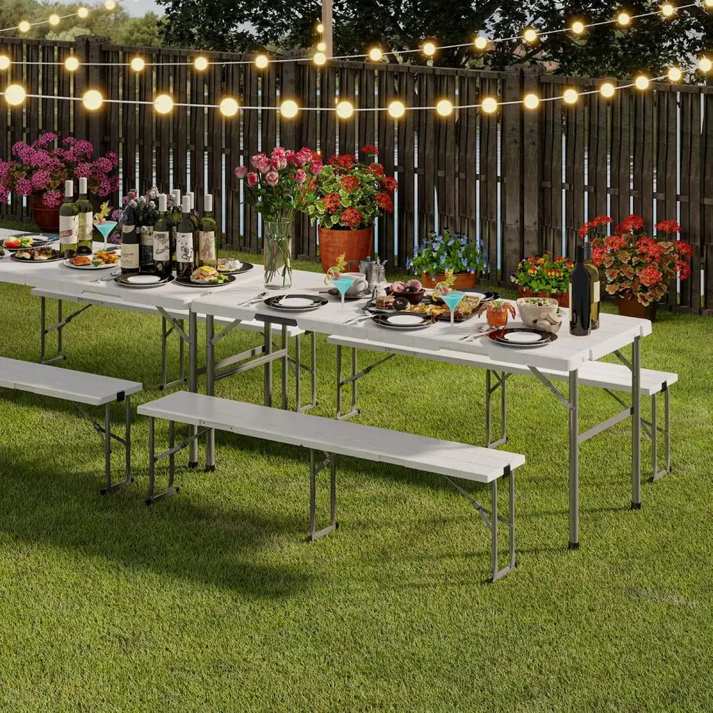 White 6-piece outdoor folding table and bench set by S And B Enterprise on a lawn with string lights