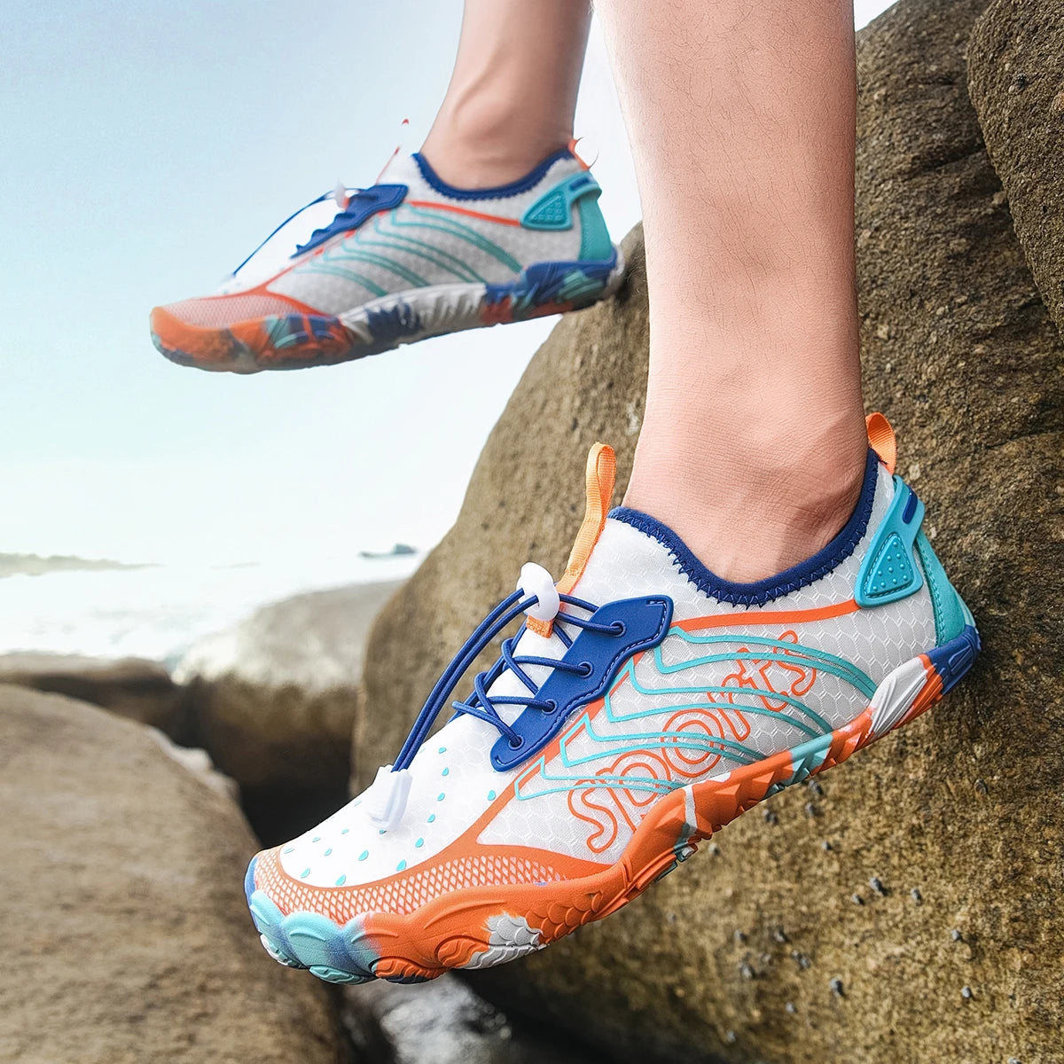 Pair of Men’s quick-dry barefoot water shoes by S And B Enterprise; breathable aqua/orange/blue sneakers with non-slip sole