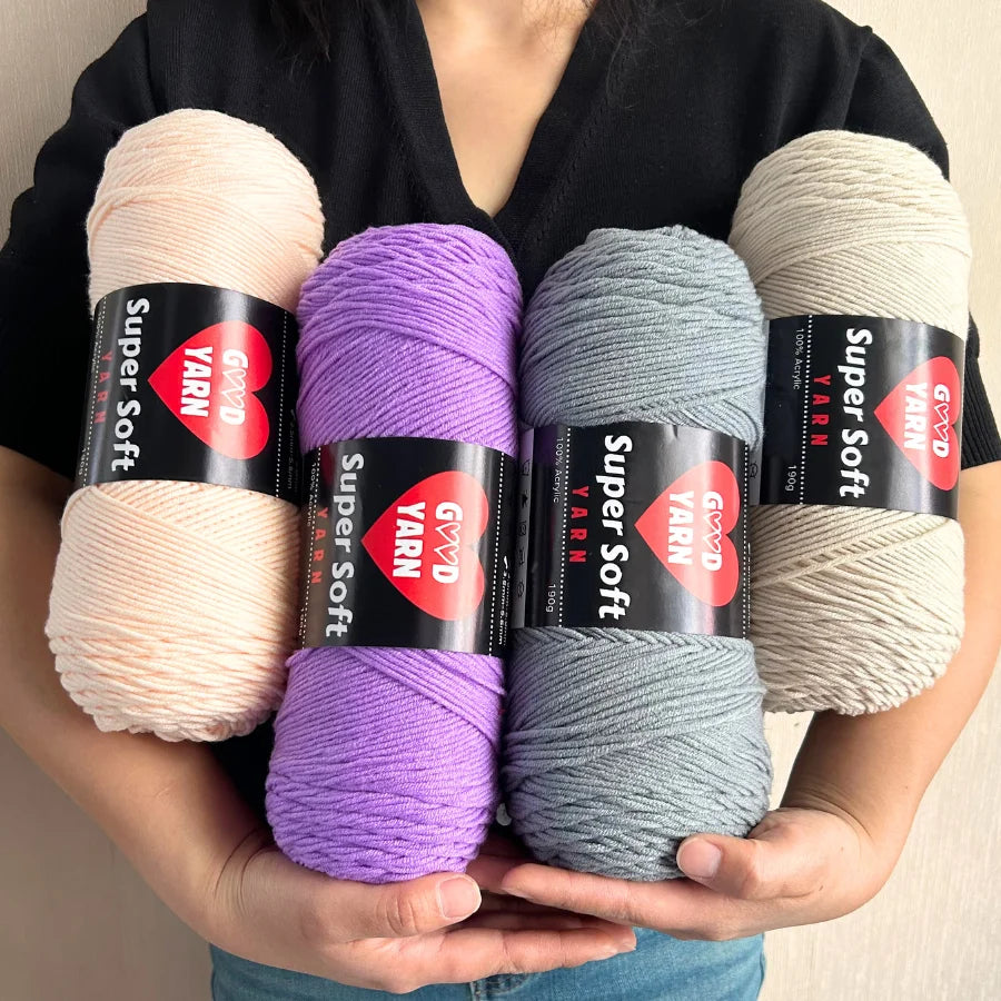 Swallow Velvet Yarn skeins; 4 skeins in peach, lavender, blue-gray, and beige.
