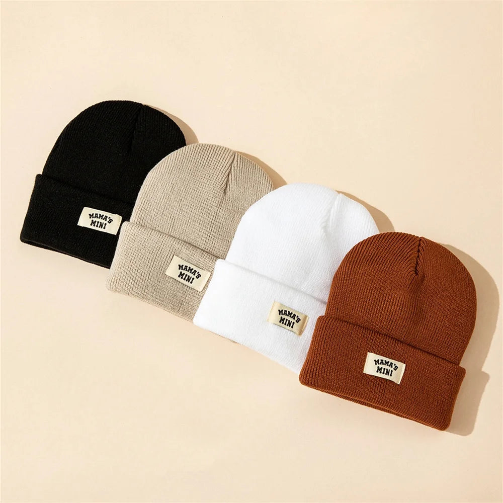 4-pack kids solid-color knit beanies in black, beige, white, brown with MAMA'S MINI label