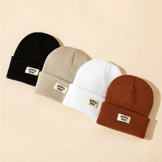 4-pack kids solid-color knit beanies in black, beige, white, brown with MAMA'S MINI label