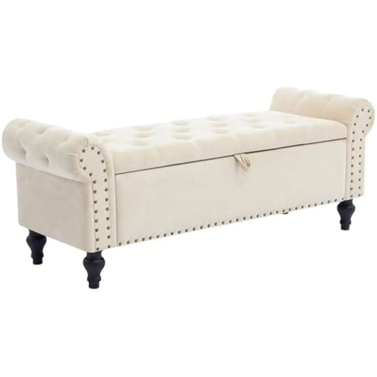 Storage bench ottoman in beige chenille with tufted top, nailhead trim, storage under lid, black turned legs.
