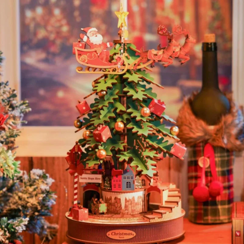 Robotime Christmas Melody Tree 3D wooden puzzle music box with Santa sleigh atop a green tree by S And B Enterprise.
