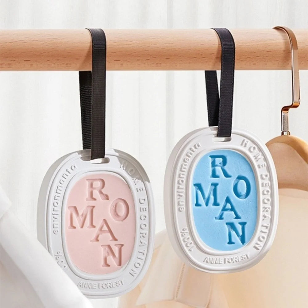Two hanging aromatherapy tablets in pink and blue for wardrobes and drawers.