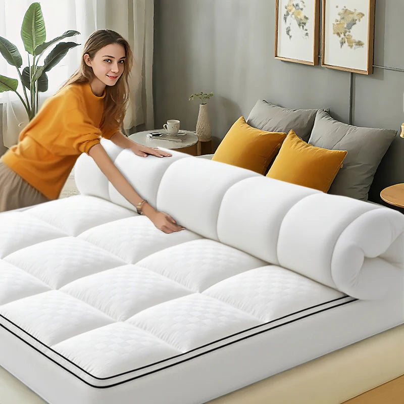 HGETVE extra thick white mattress topper being installed on a bed; quilted pattern and rolled top edge.
