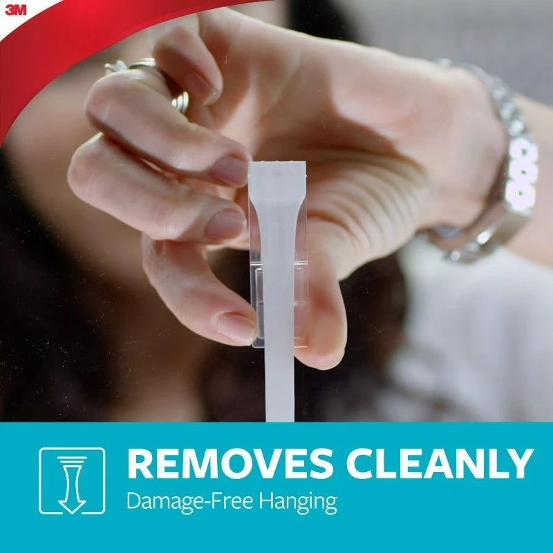 Removable bathroom hook in clear packaging; hand peels backing to reveal white hook, 3M branding.