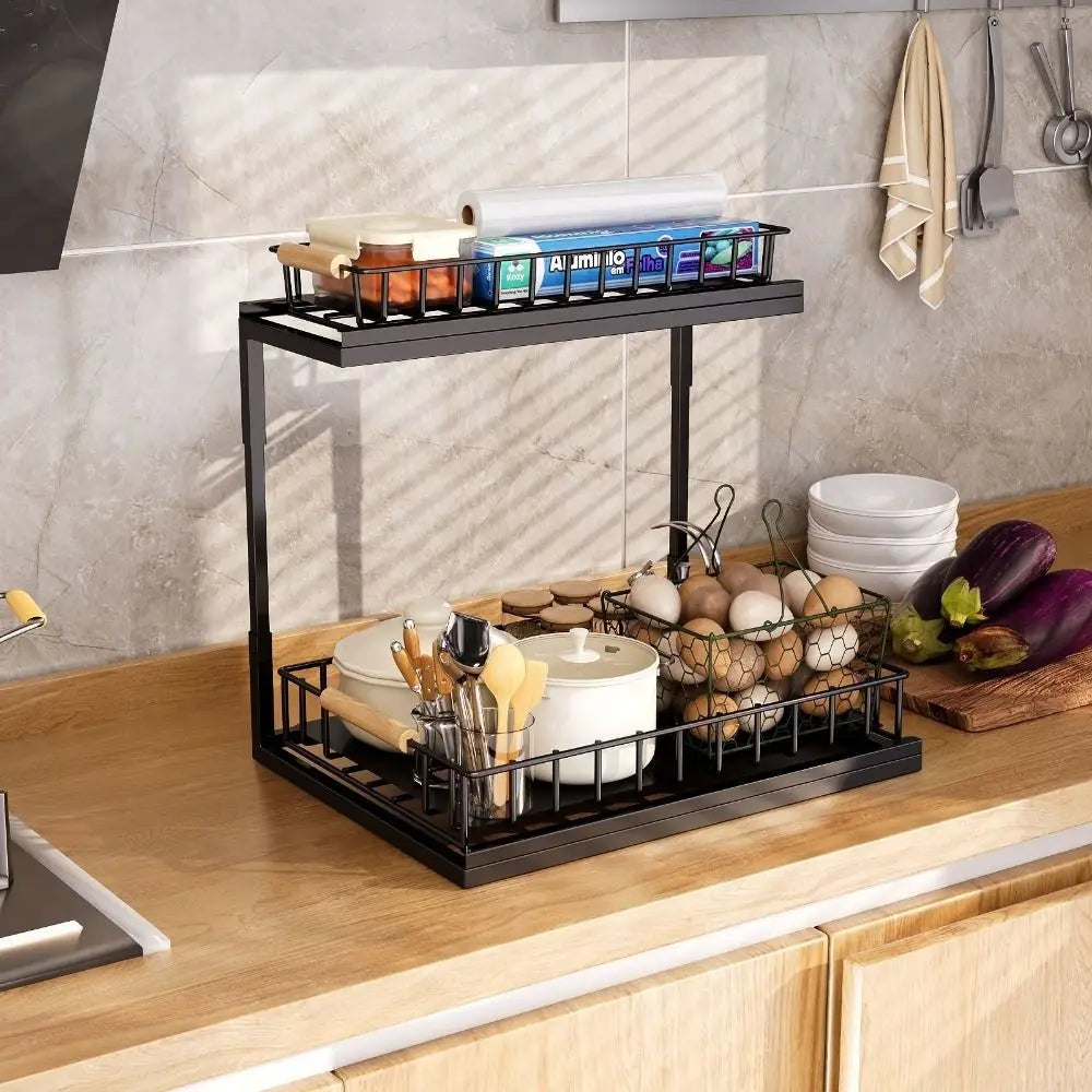 Carbon steel 2-tier under-sink organizer with rustproof slide-out top shelf and bottom wire basket in black for space-saving kitchen storage.