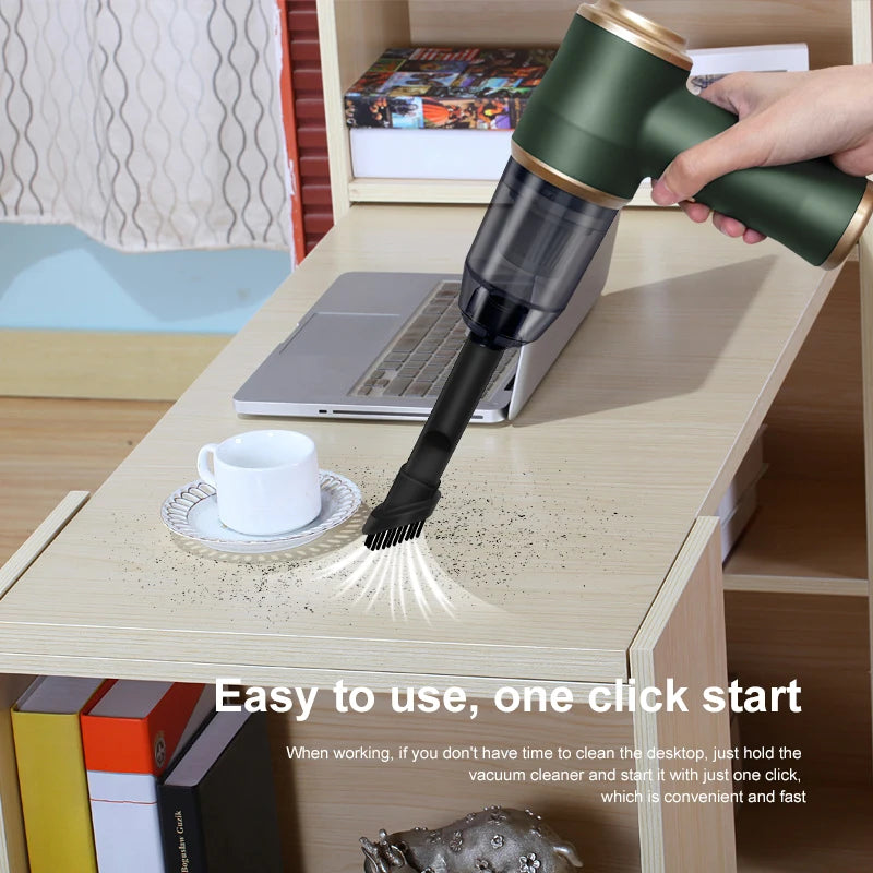 Wireless car vacuum cleaner, green with gold trim, handheld dust canister, cleaning desk near laptop.