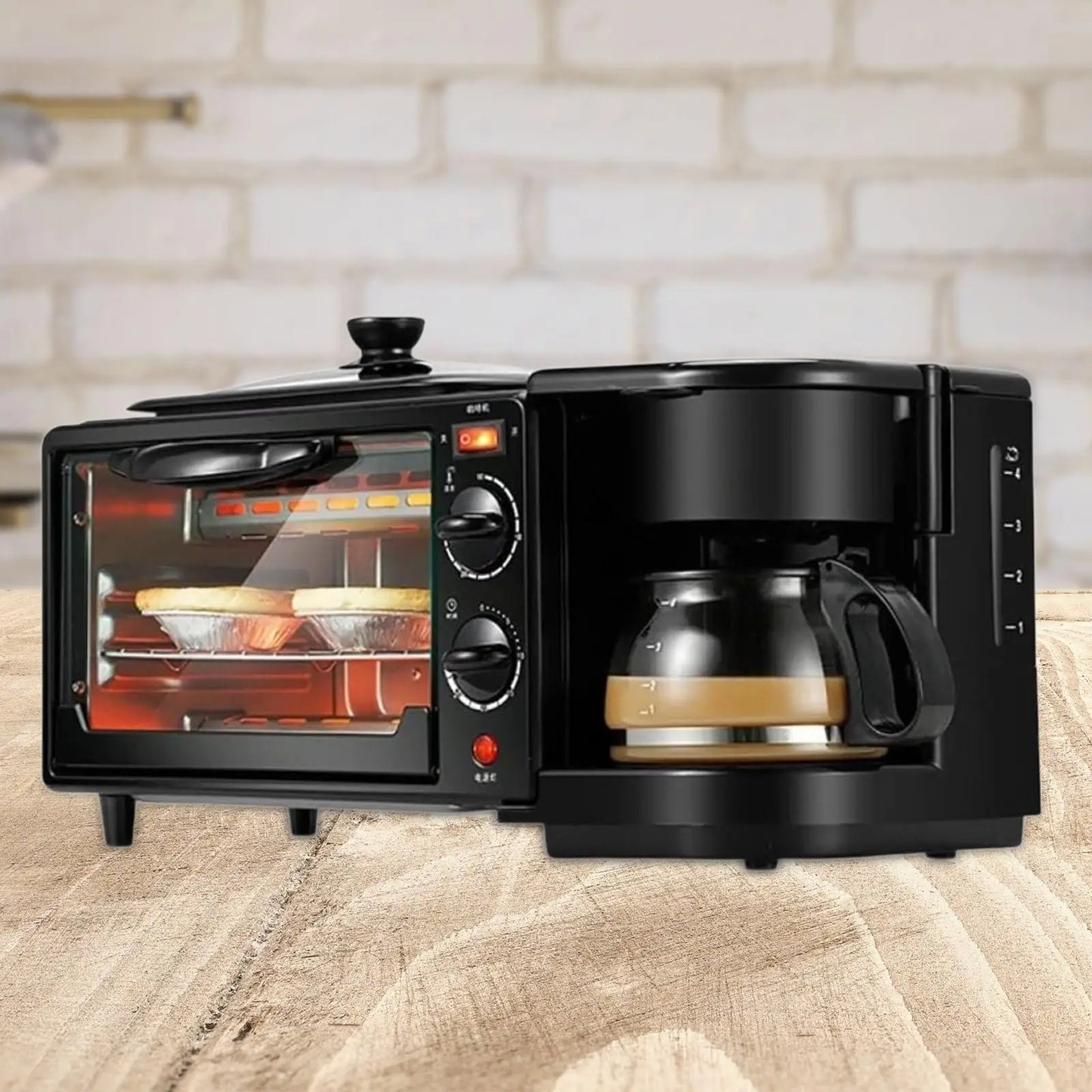 Black 3-in-1 breakfast maker with oven and coffee carafe; glass-door toaster oven on left.