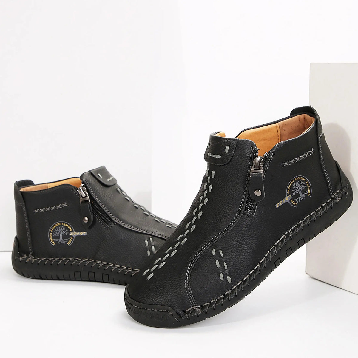 Womens black leather ankle boots with stitching and logo patch by S And B Enterprise