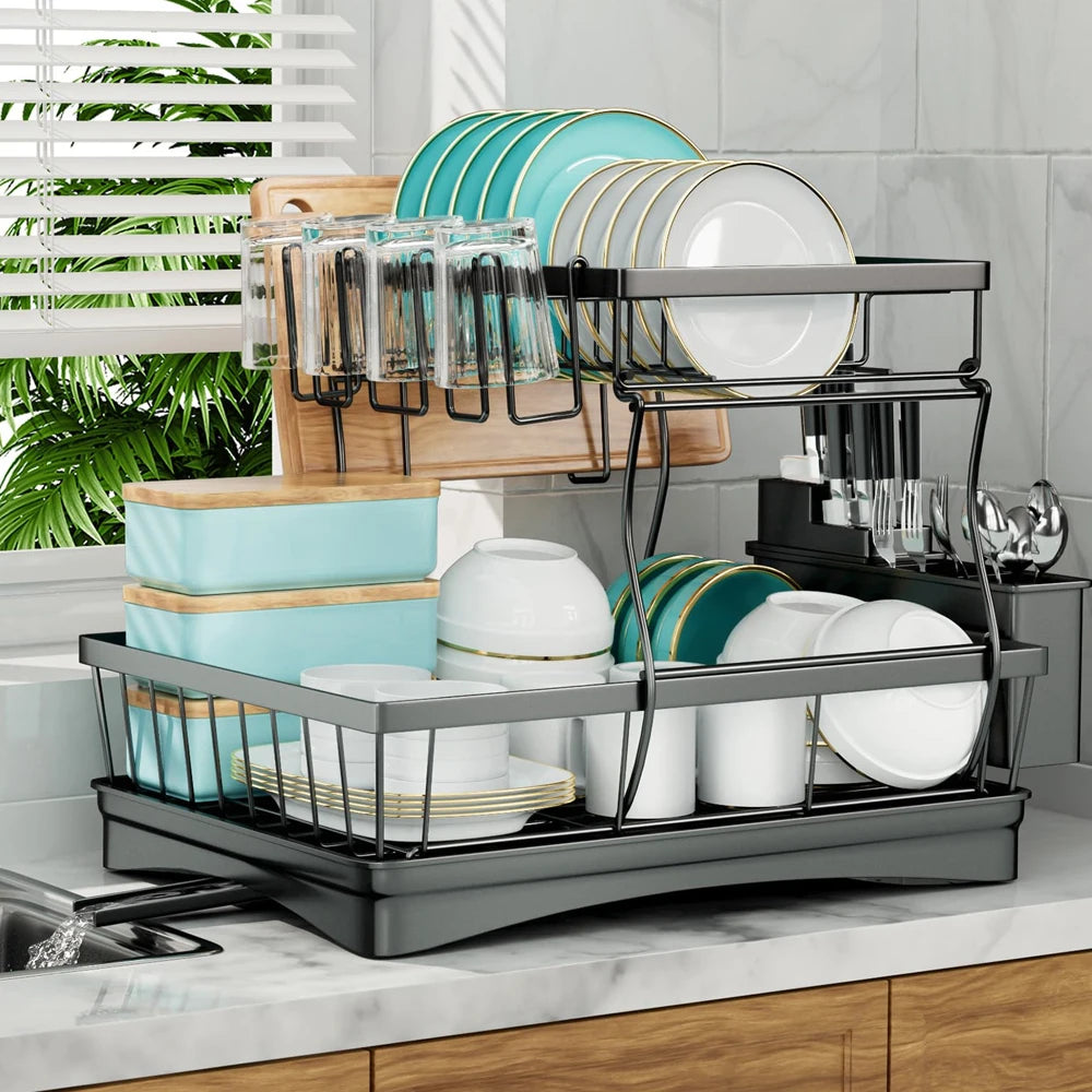 Large 2-tier dish drying rack in black metal with gray tray on the counter, holding turquoise plates, bowls and mugs.
