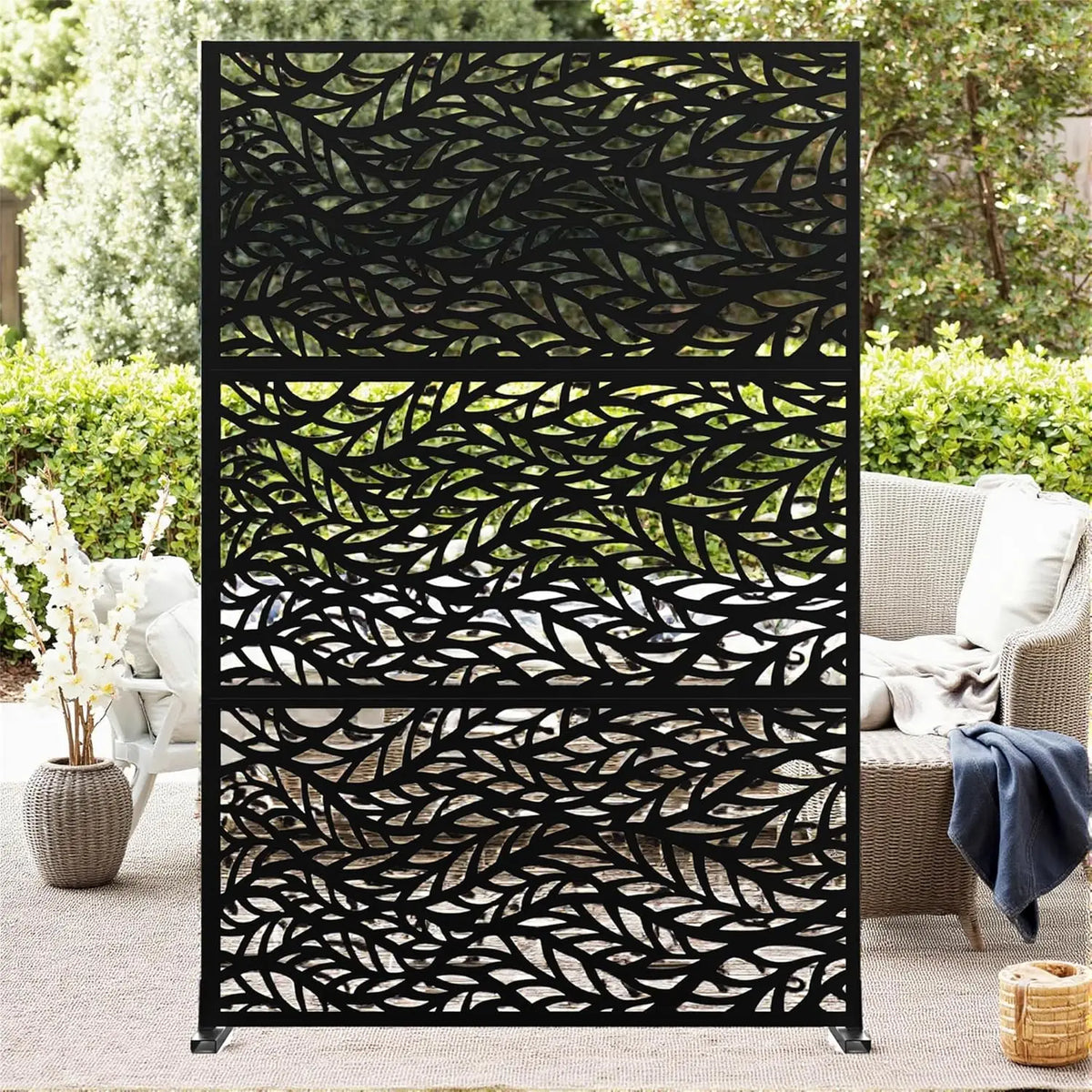 Decorative garden privacy screen with stand, black metal leaf-pattern panels for outdoor backyard patio.