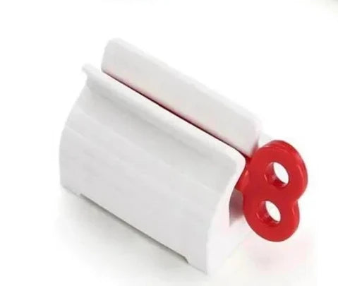 Toothpaste tube squeezer by S And B Enterprise; white plastic with red end wheel for easy, mess-free squeezing.
