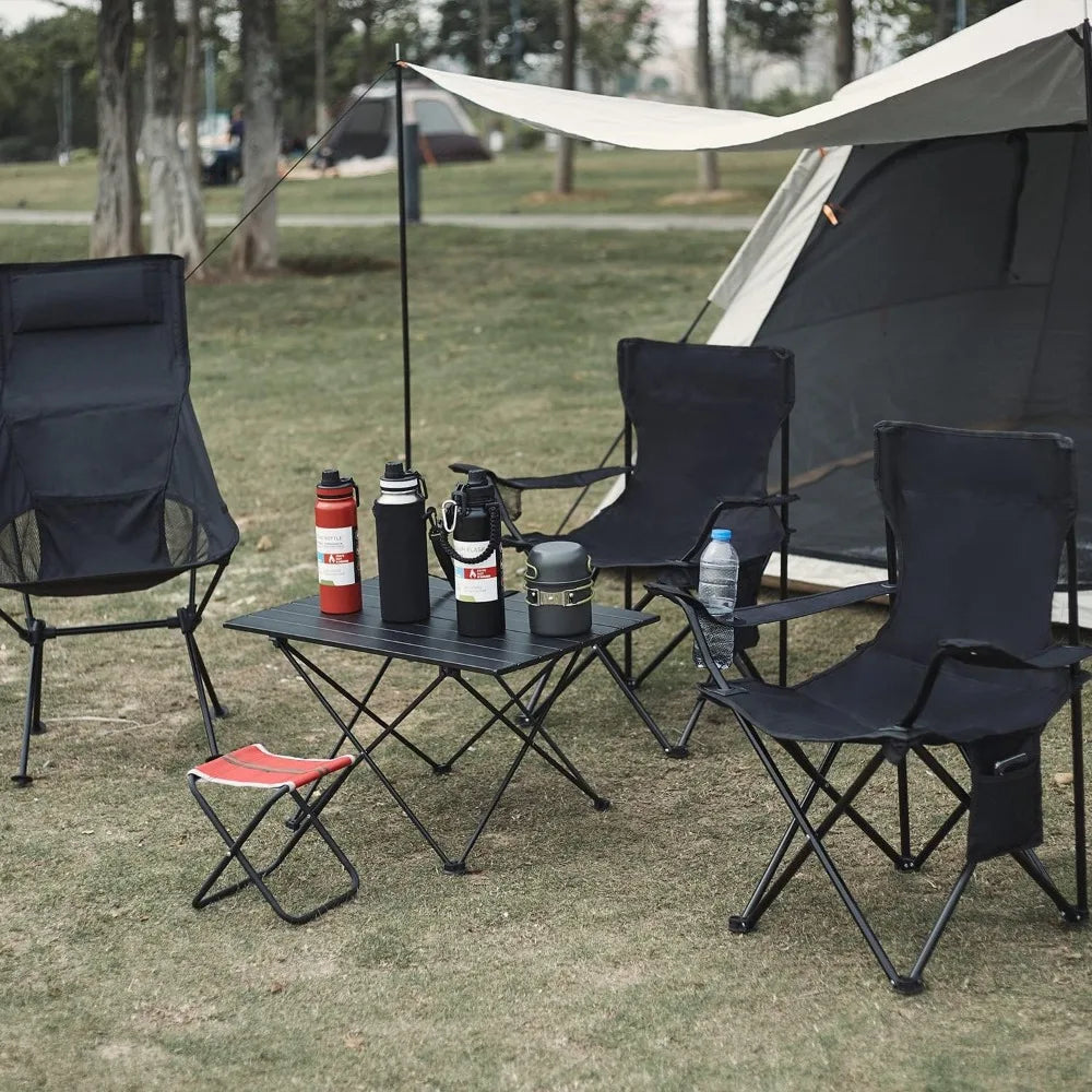 Lightweight folding camp chairs in black with a matching table and camping gear