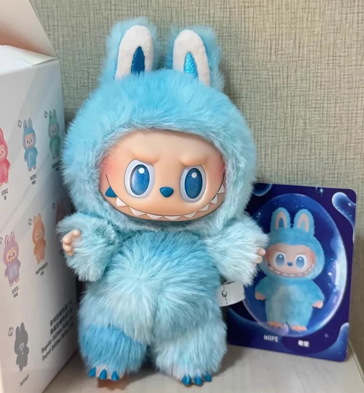 Labubu plush doll in blue macaron color with fluffy fur and bunny ears