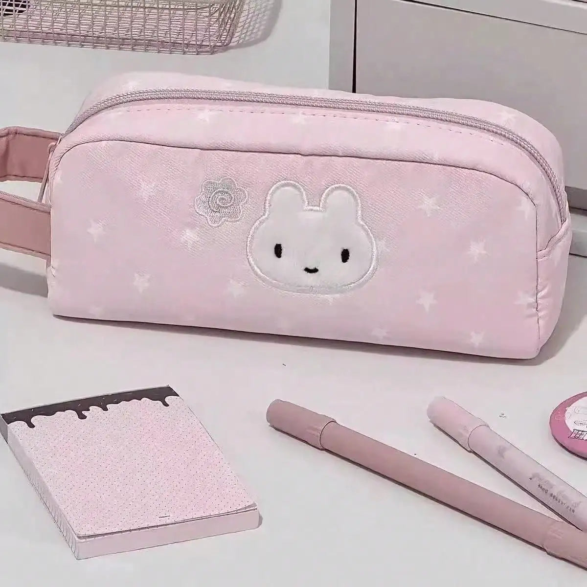 Pink soft-fabric pencil case with bunny embroidery and star prints, large-capacity pen pouch.